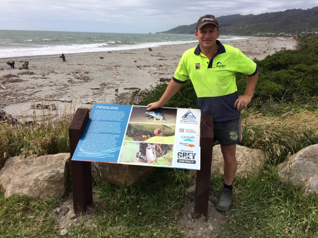 Local builder, Bernie Fahey, installing the penguin panel at Cobden