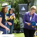 Kristine Hickford receives the first copy of the education resource as Zoe and Inger look on reduced