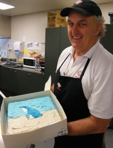 New World baker and his penguin cake