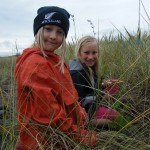 Ursina Perry (pippin) and Rhiannon Cutter (guide) help re-plant penguin habitat - square